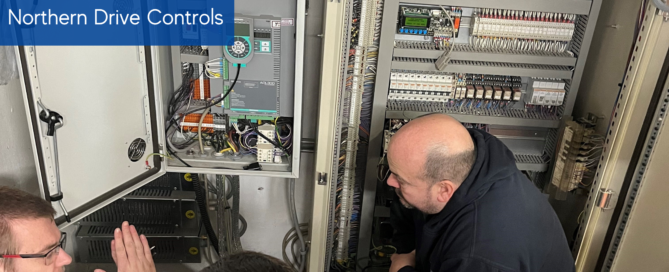 Drive training with Northern Drive Controls, four men crouched in front of controls