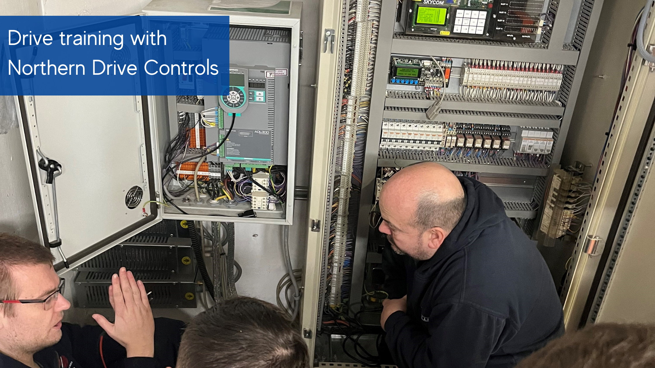 ndc-drive-training Drive training with Northern Drive Controls, four men crouched in front of controls