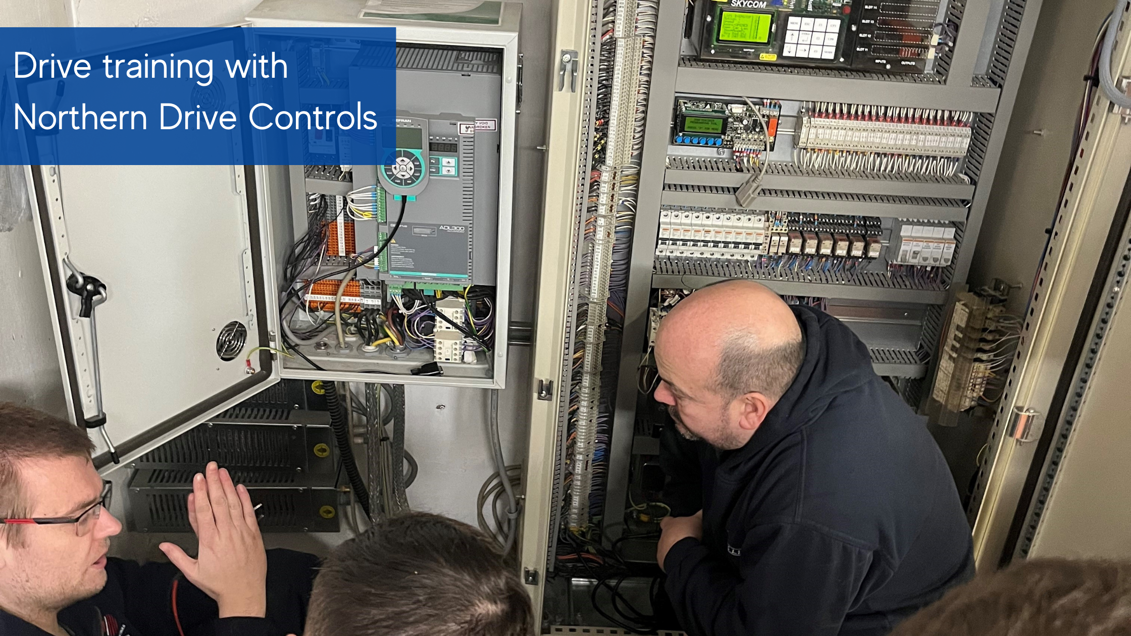 Drive training with Northern Drive Controls, four men crouched in front of controls