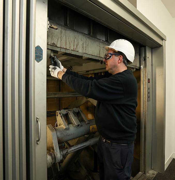 Apex engineer repairing a lift