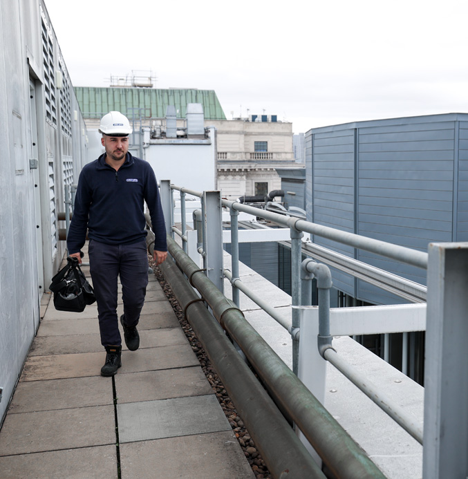 lift-engineer-on-roof Apex lift engineer on the roof of a building